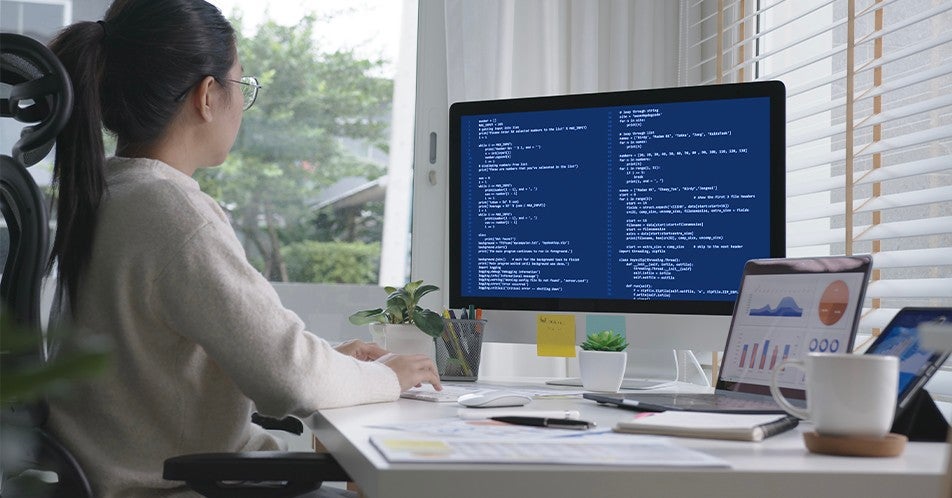 woman coding on computer